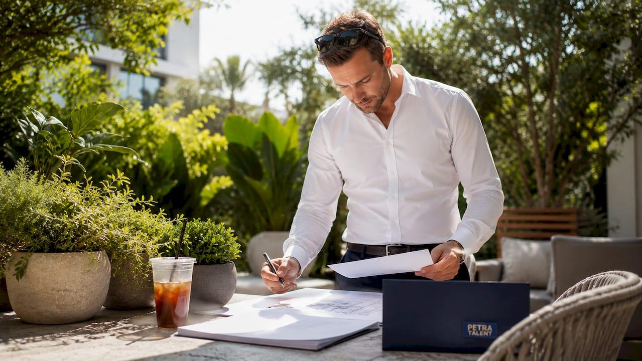 HVAC project manager reviewing resumes and plans
