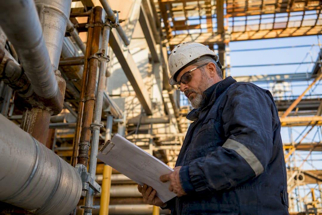 Mechanical general foreman inspecting job site plans