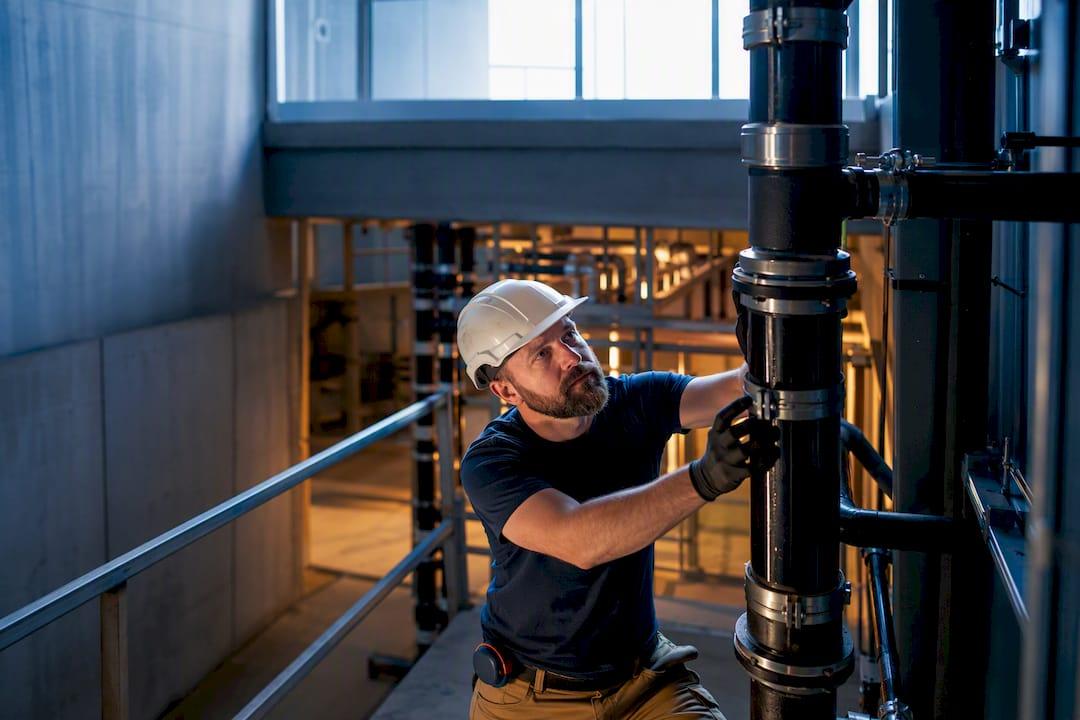 Plumbing foreman inspecting commercial pipe installation